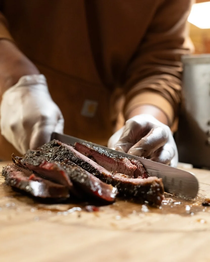 Delicious smoked brisket served on a wooden platter with sides.