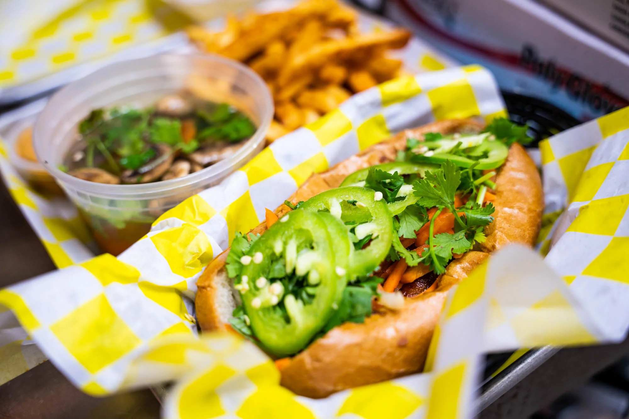 Vietnamese banh mi combo with a side of soup and fries