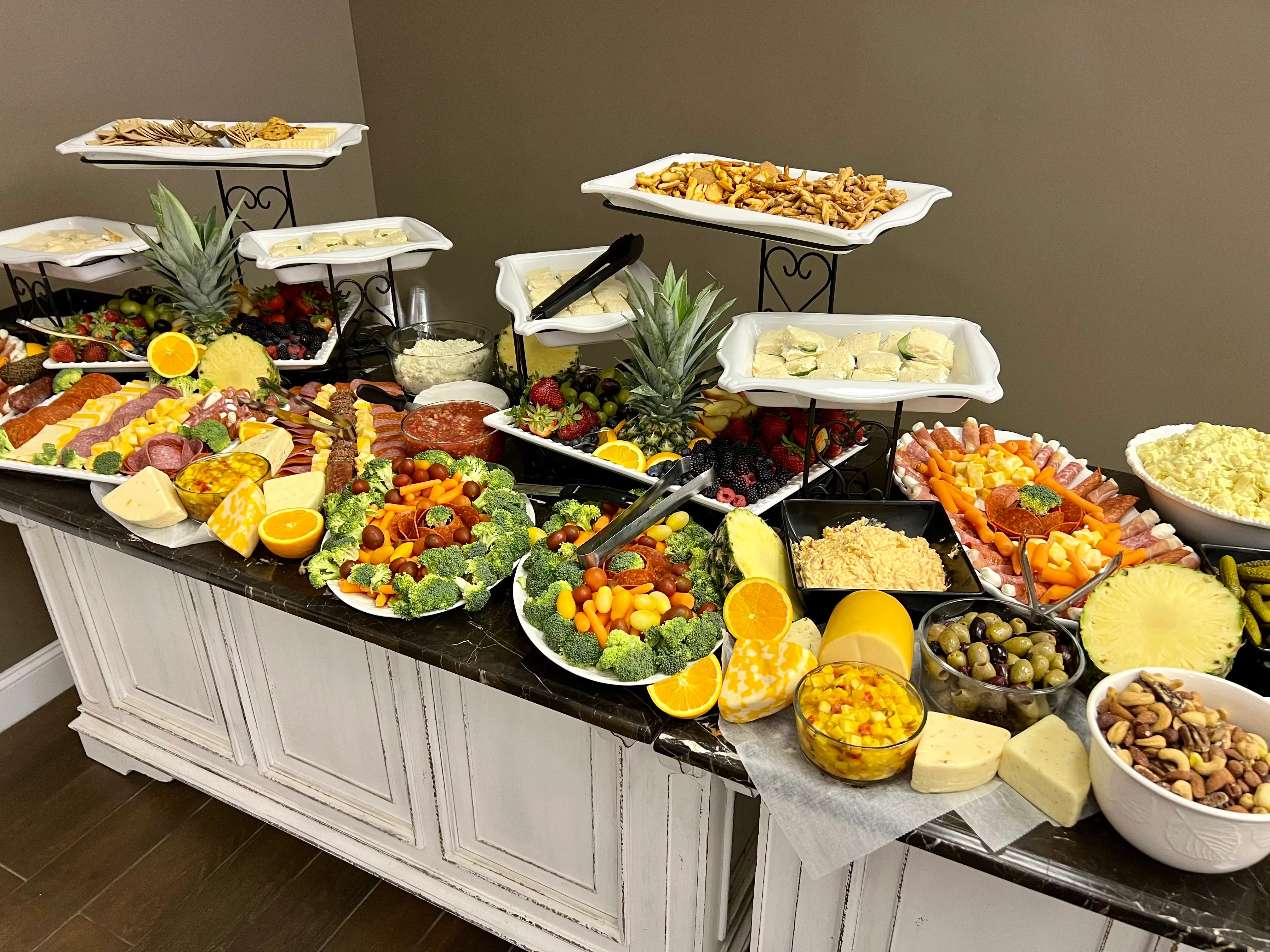 Assorted charcuterie and cheese platter with fresh fruits and vegetables