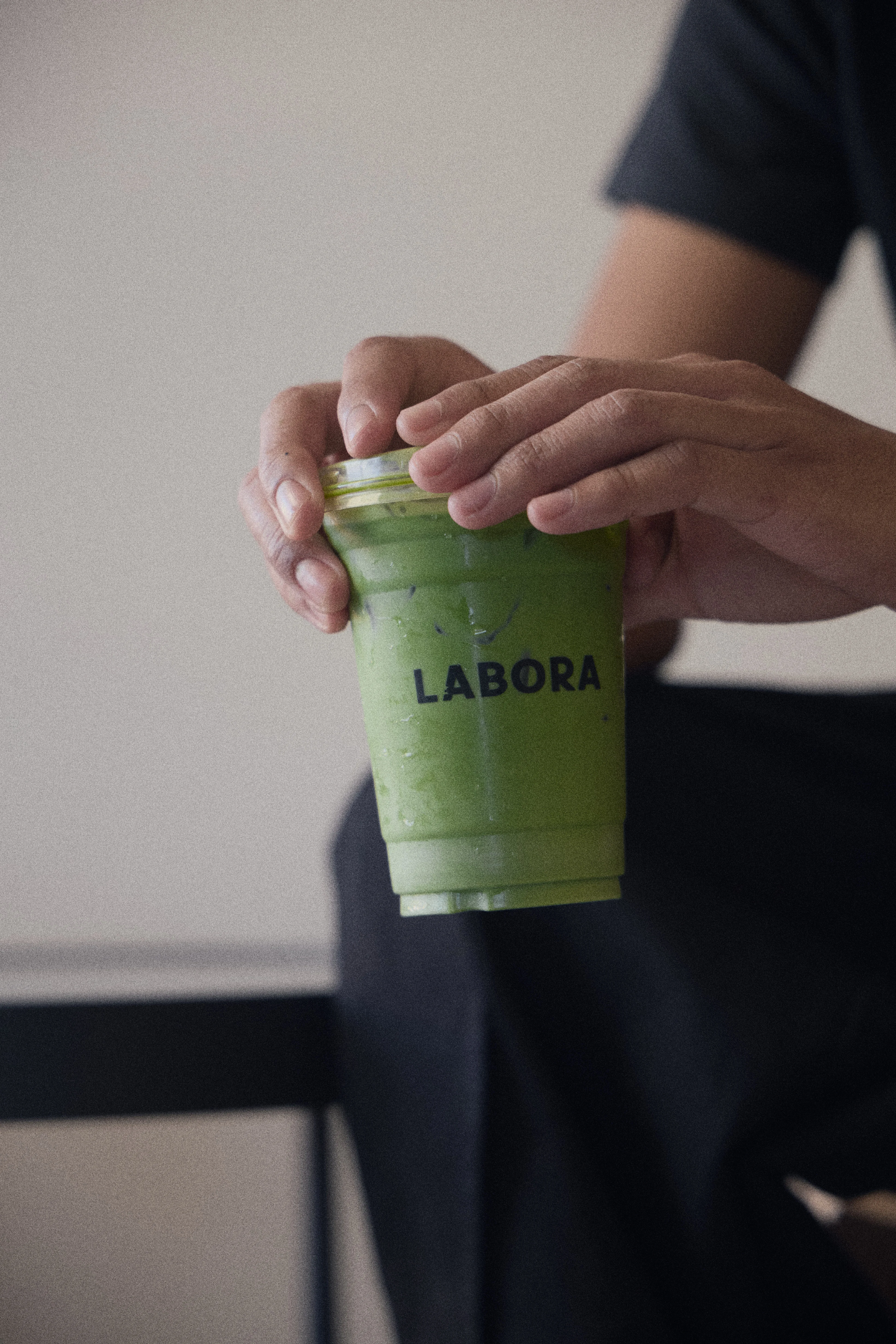 Iced matcha latte in a clear cup from Labora