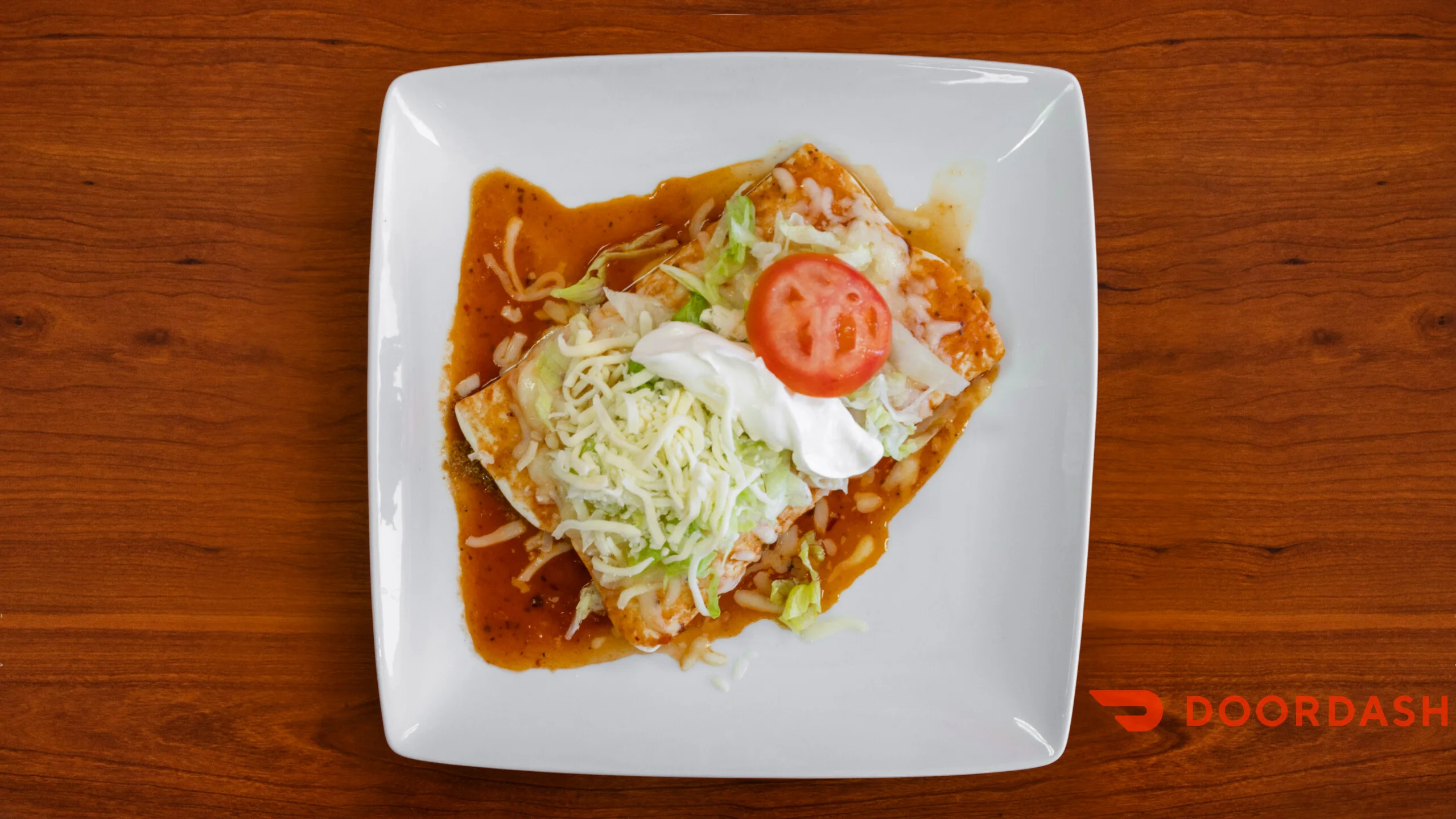 Delicious Mexican enchiladas topped with cheese and fresh vegetables