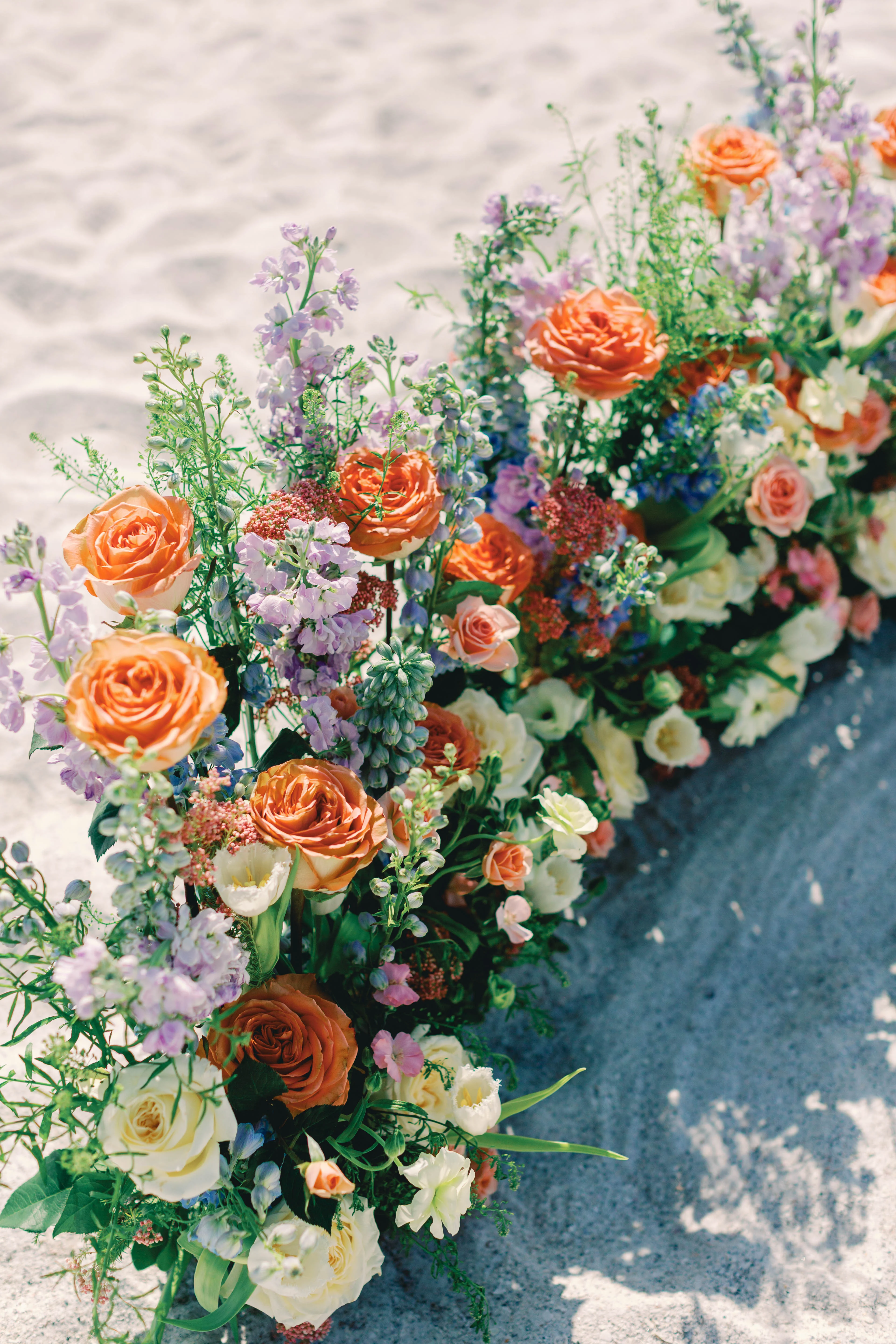 Vibrant floral arrangement on sandy beach