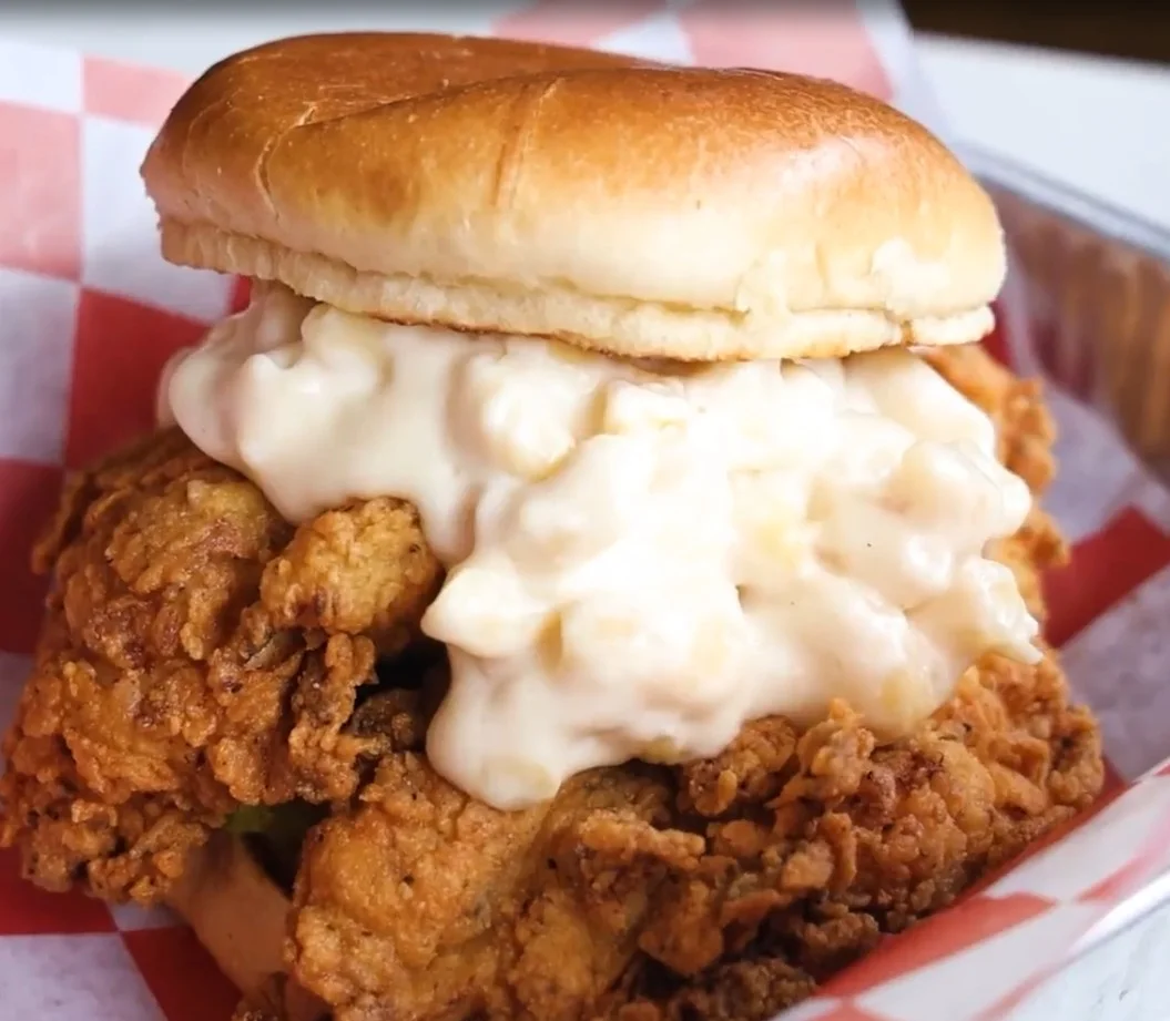 Crispy fried chicken sandwich with creamy sauce on a toasted bun