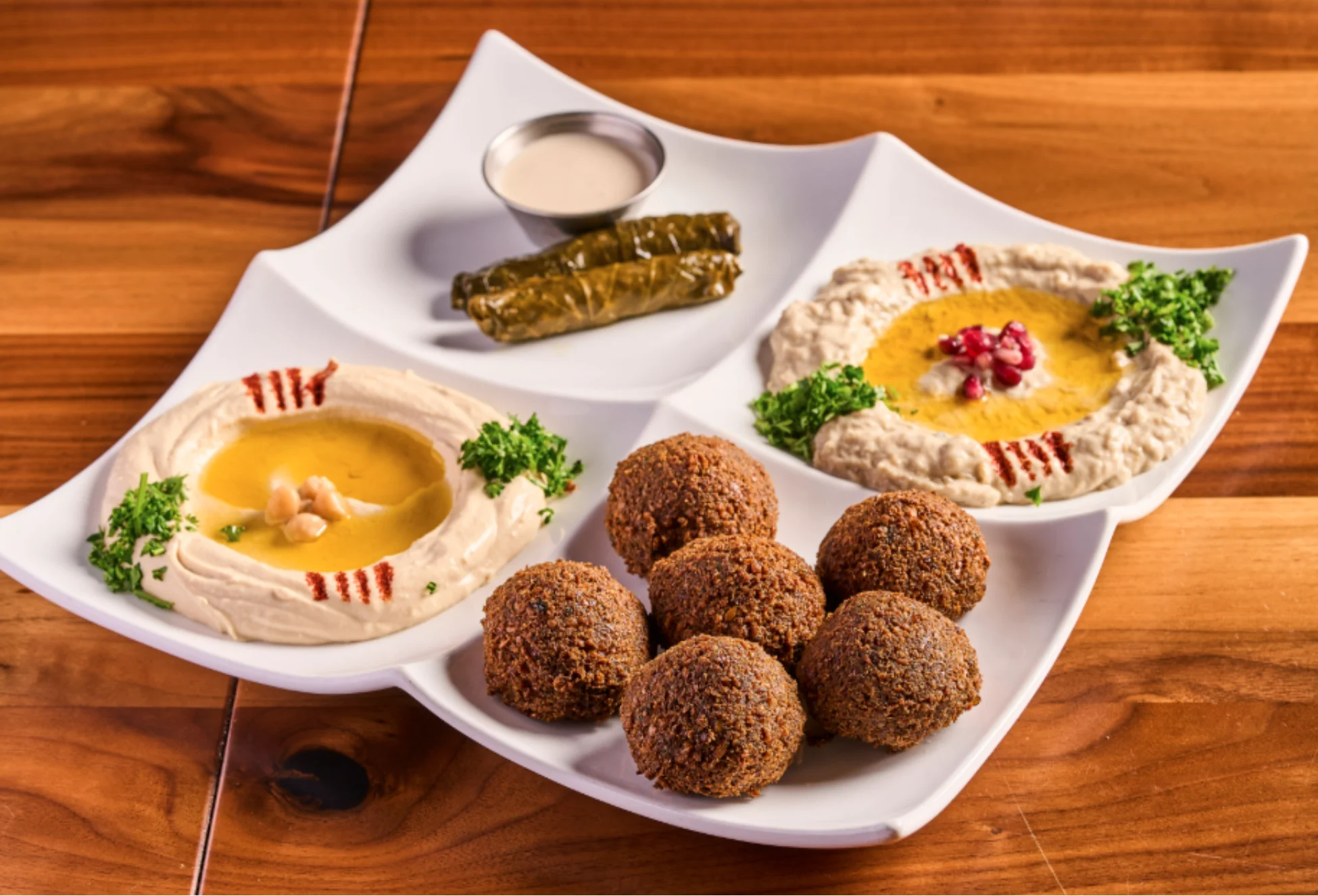 Veggie Sampler with 6 falafel, 2 grape leaves, hummus, baba ghanoush, and fresh pita bread.