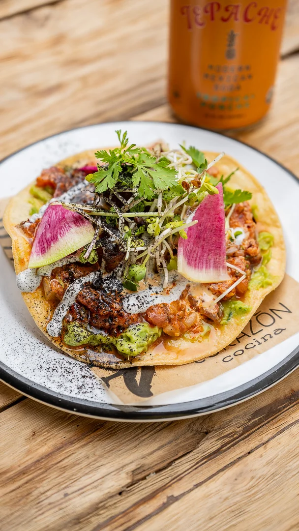 Colorful Mexican taco topped with fresh ingredients