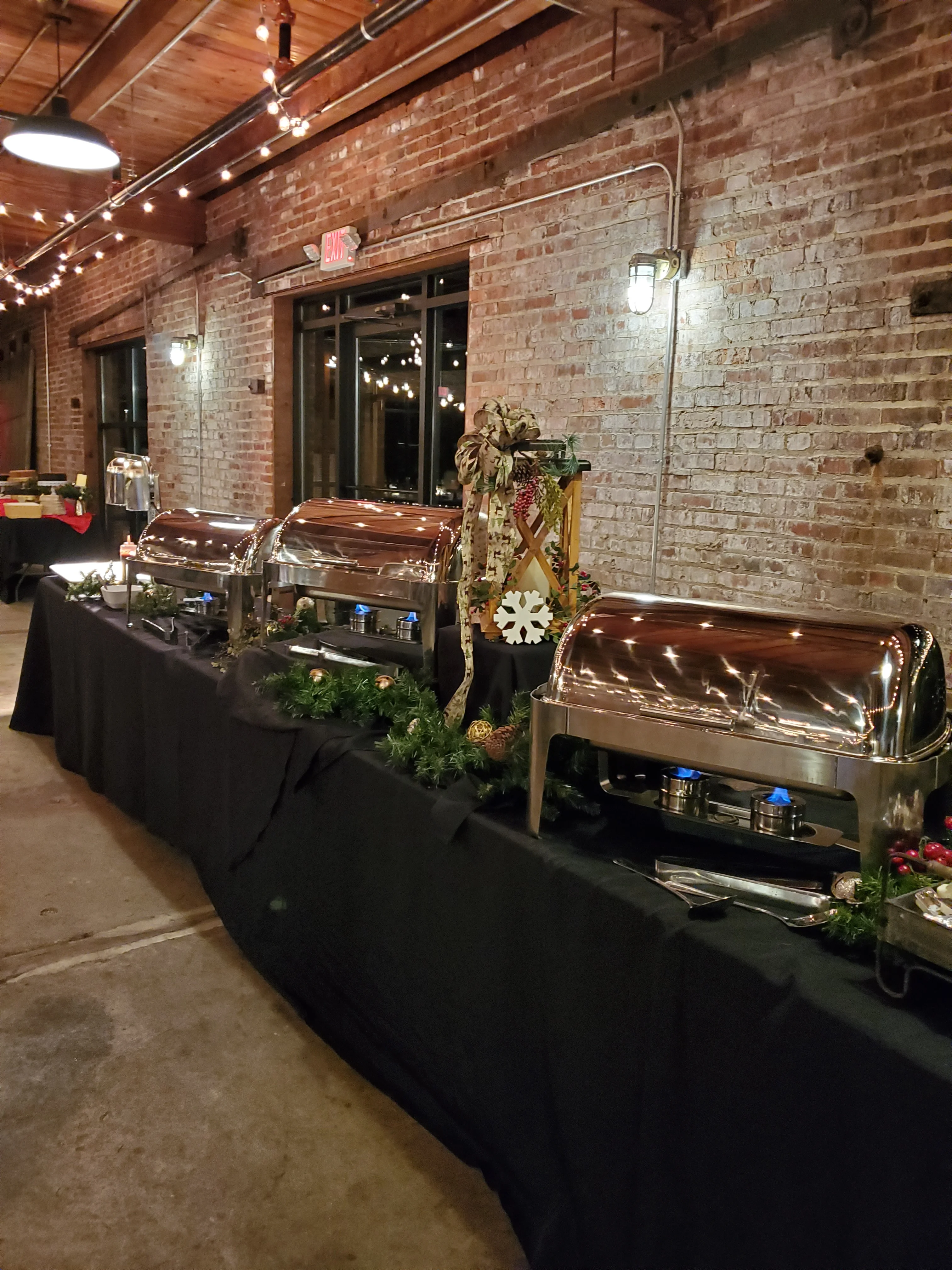 Elegant buffet setup with chafing dishes and festive decor