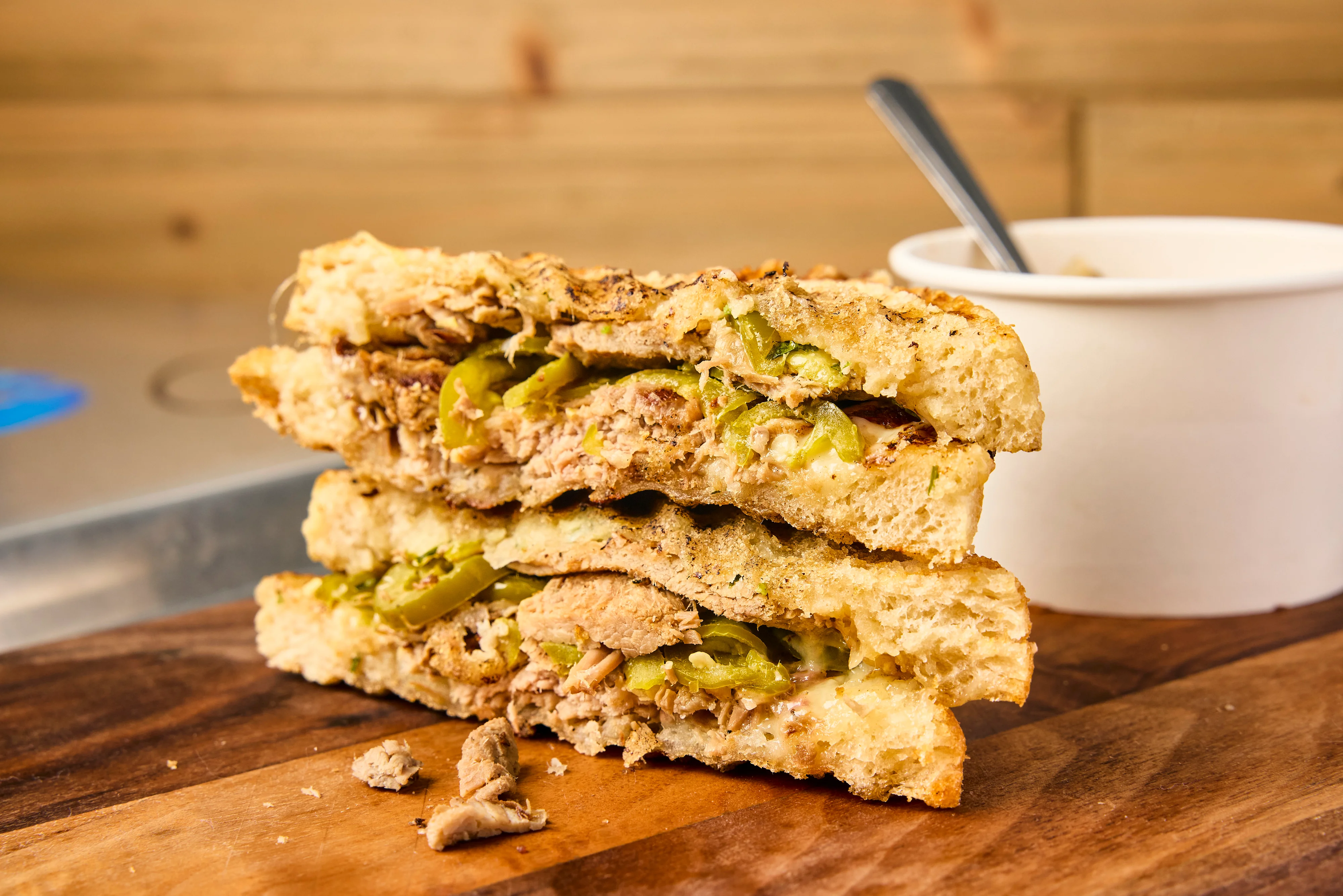 The Revelo has pork shoulder marinated in mojo sauce for 24 hours, then roasted and sliced with caramelized onion, picked jalapeno, fresh cilantro, roasted garlic mayo and Swiss cheese on our grilled sourdough.