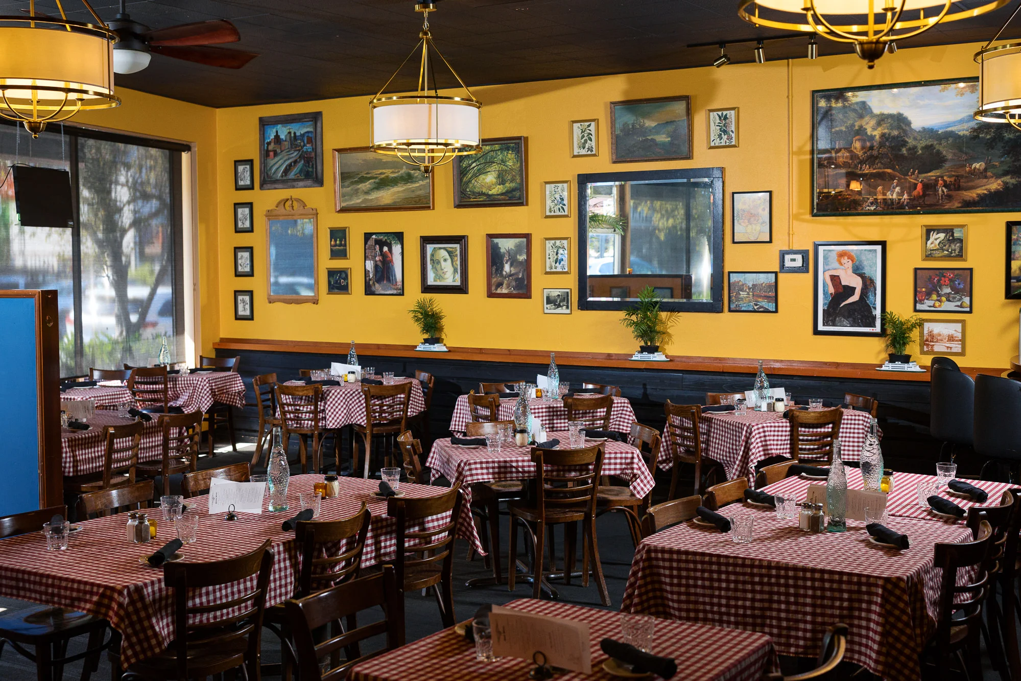 Cozy restaurant interior with checkered tablecloths and vibrant artwork