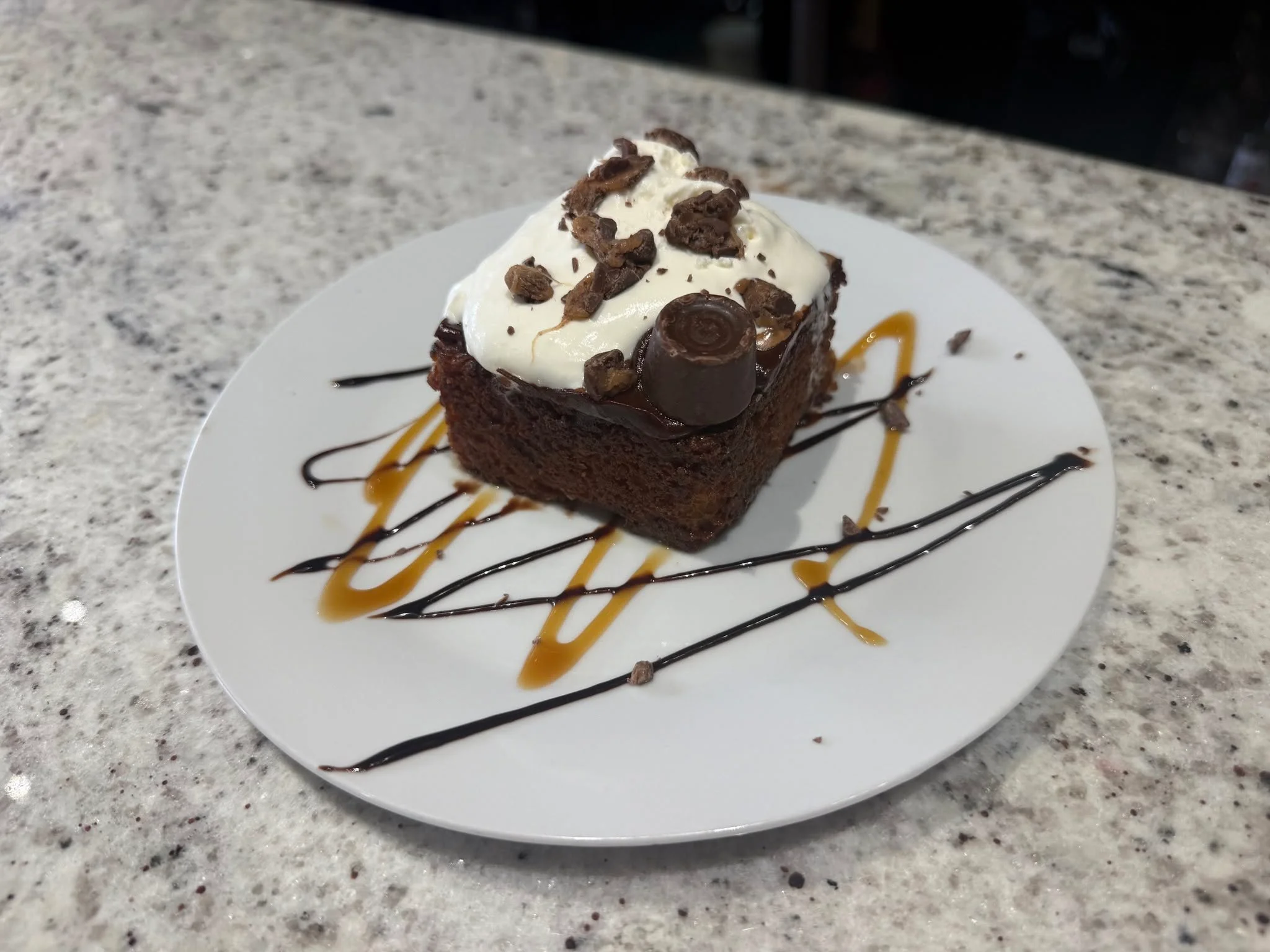 Decadent chocolate brownie dessert with whipped cream