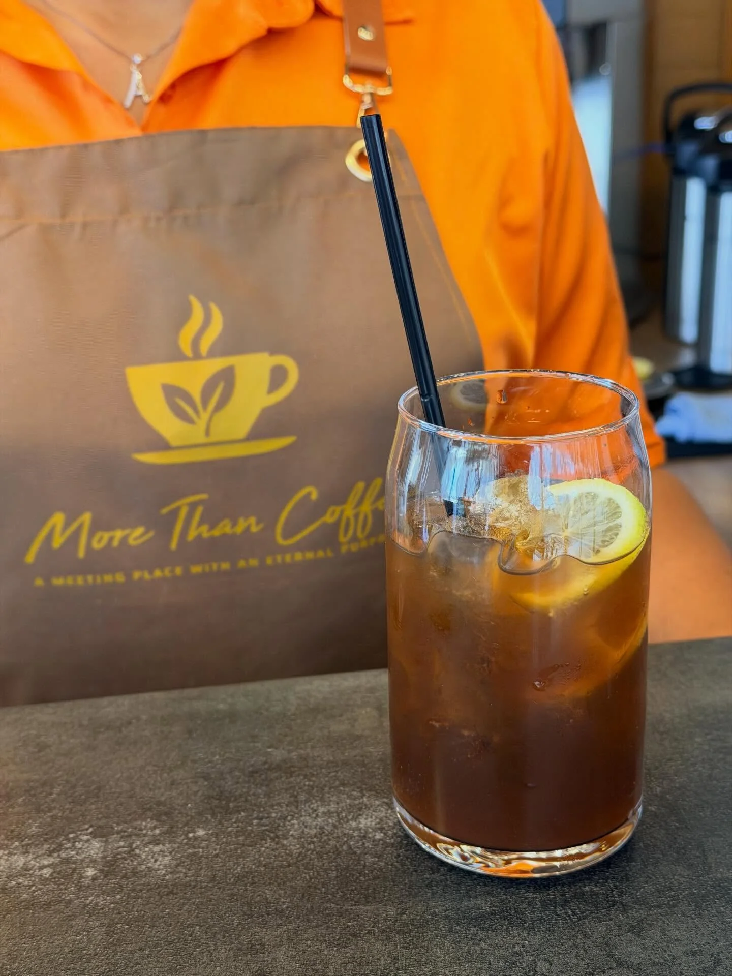 Refreshing iced coffee with lemon slice in a cozy café setting