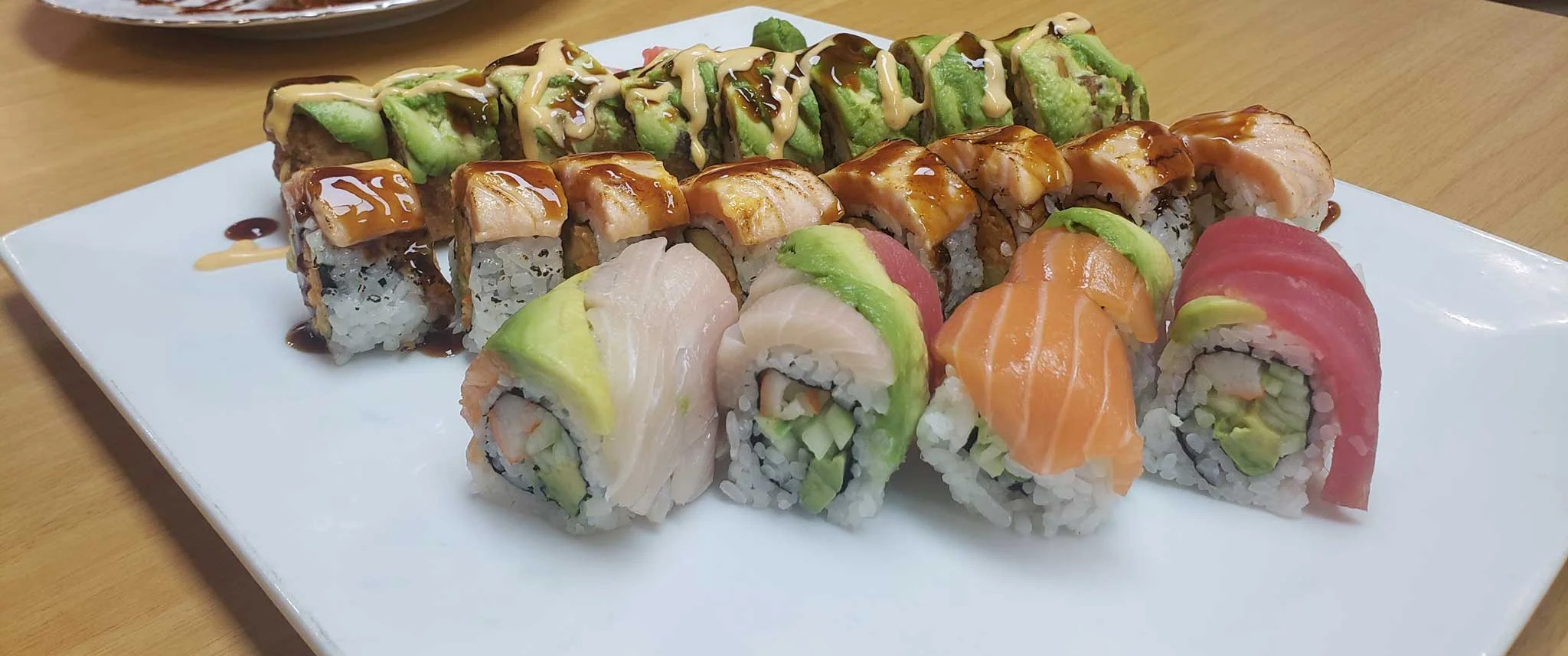 Assorted sushi platter featuring colorful rolls and sashimi