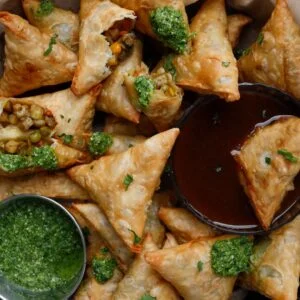 Crispy Indian samosas with mint chutney and tamarind sauce