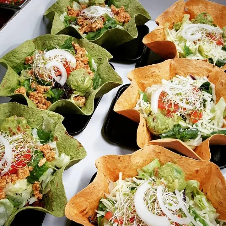 Colorful taco salad bowls with fresh ingredients