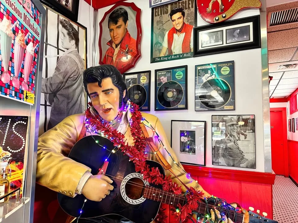 Vibrant diner interior with Elvis memorabilia and festive decorations