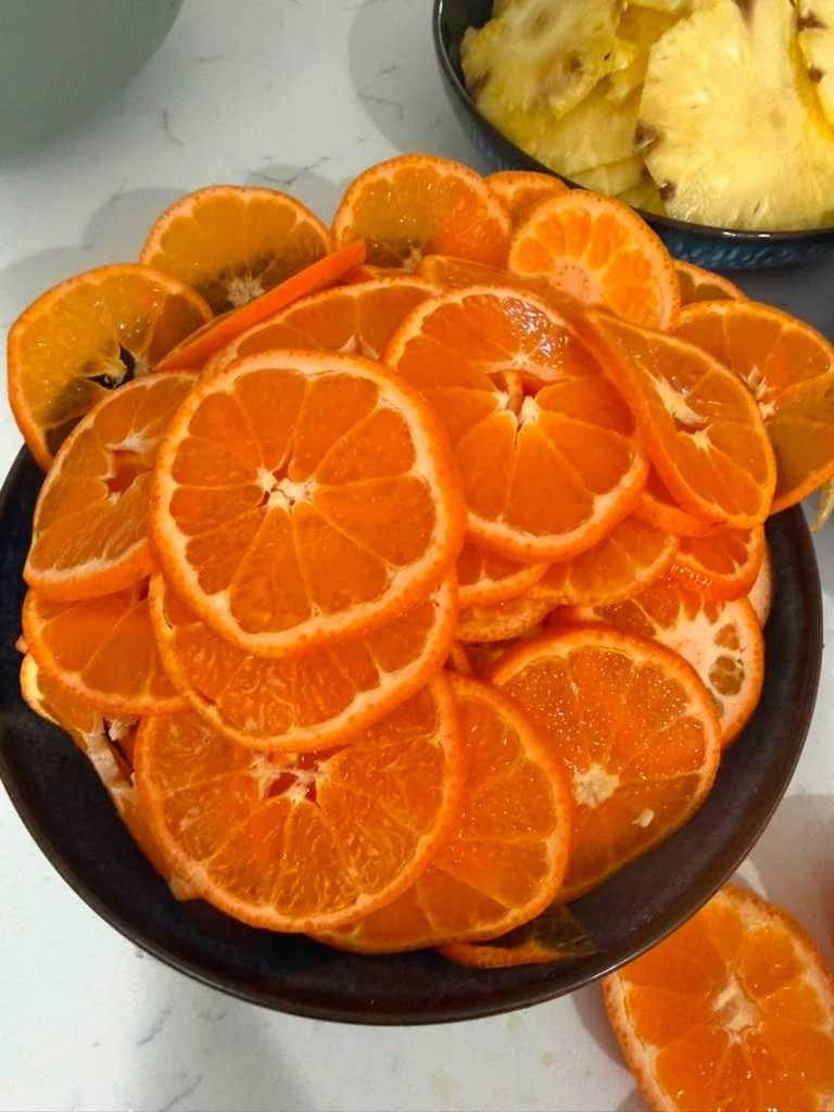 Freshly sliced oranges arranged in a bowl for a vibrant fruit display