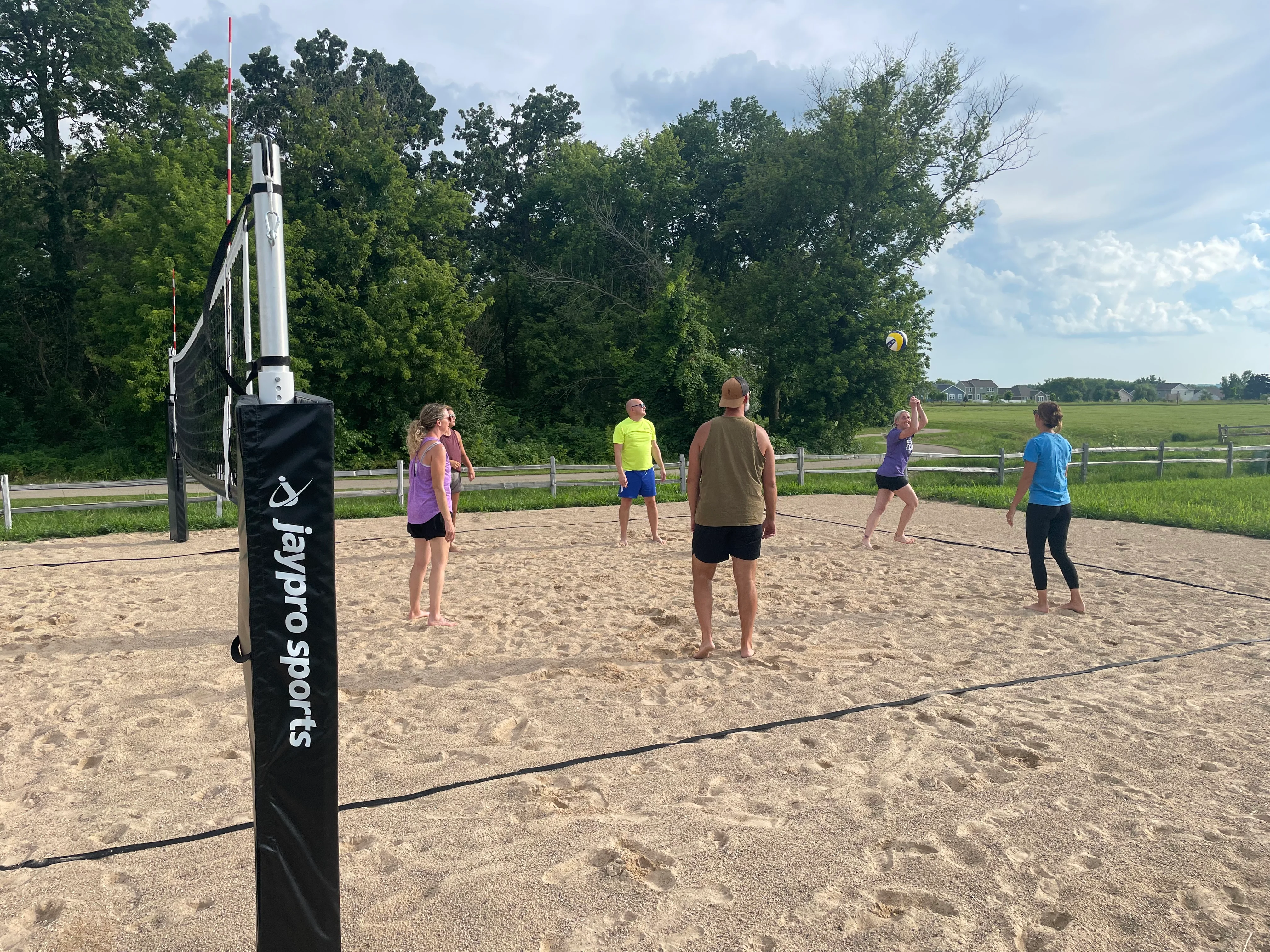 Group playing beach volleyball on a sunny day
