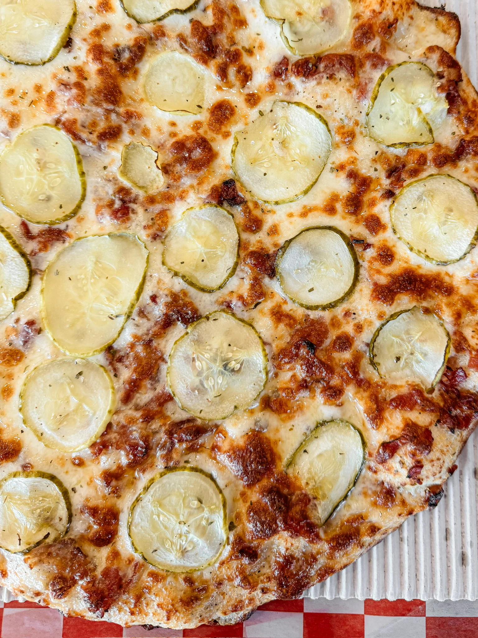 Pickle pizza with melted cheese and crispy crust