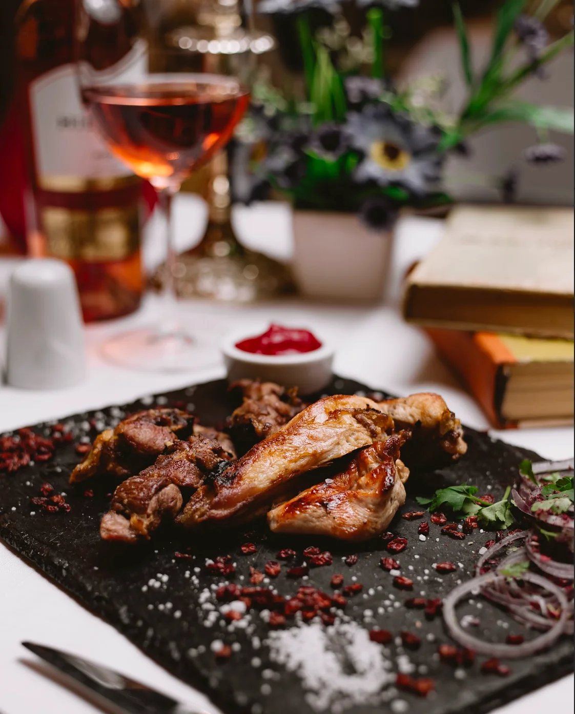 Grilled chicken platter with sauce in a cozy dining setting