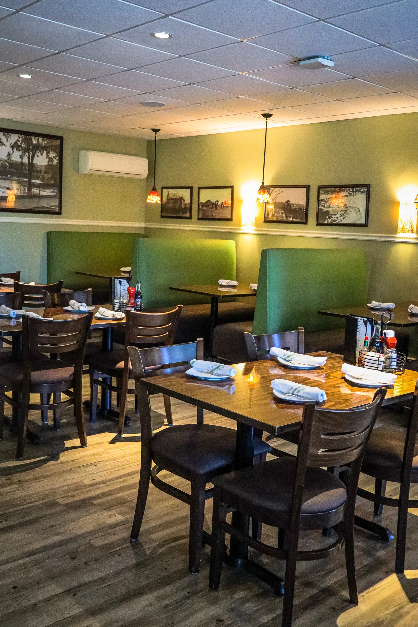 Cozy restaurant interior with green booths and warm lighting