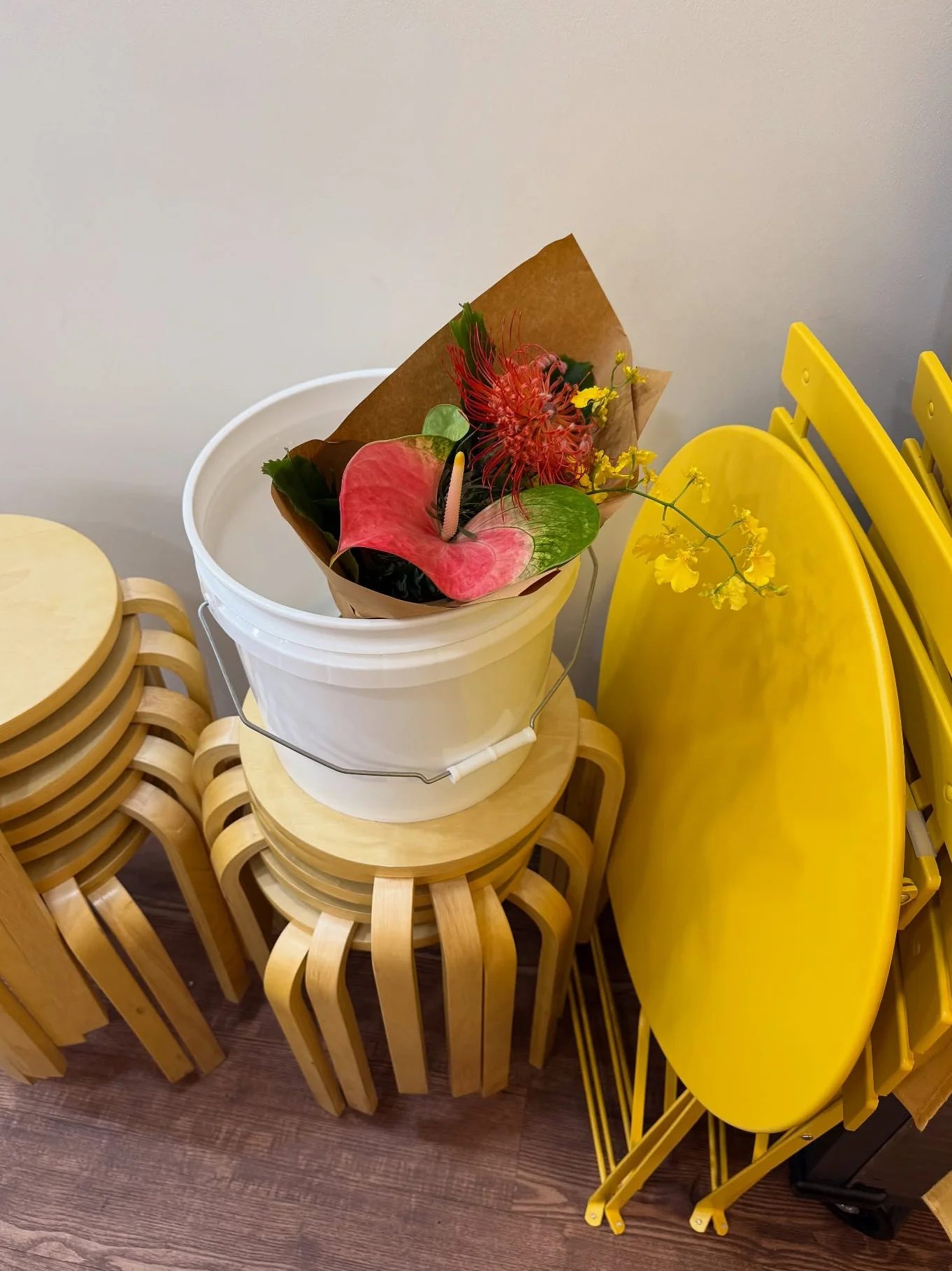 Colorful floral arrangement in a white bucket