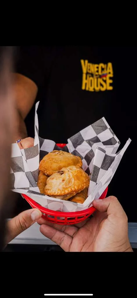 Basket of Latin American empanadas served with checkered paper