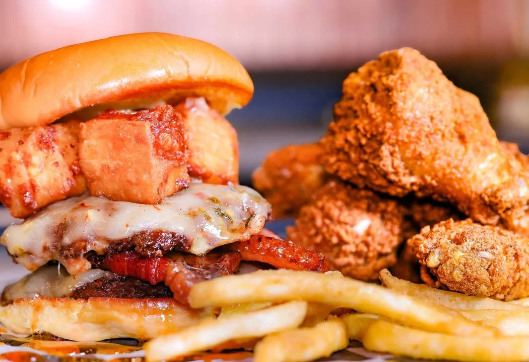 Loaded burger with fried chicken and fries