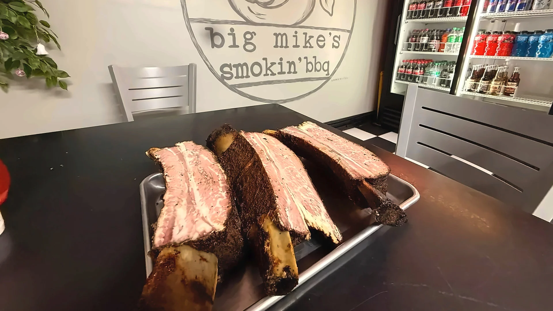 Smoked barbecue ribs with a flavorful bark served on a metal tray