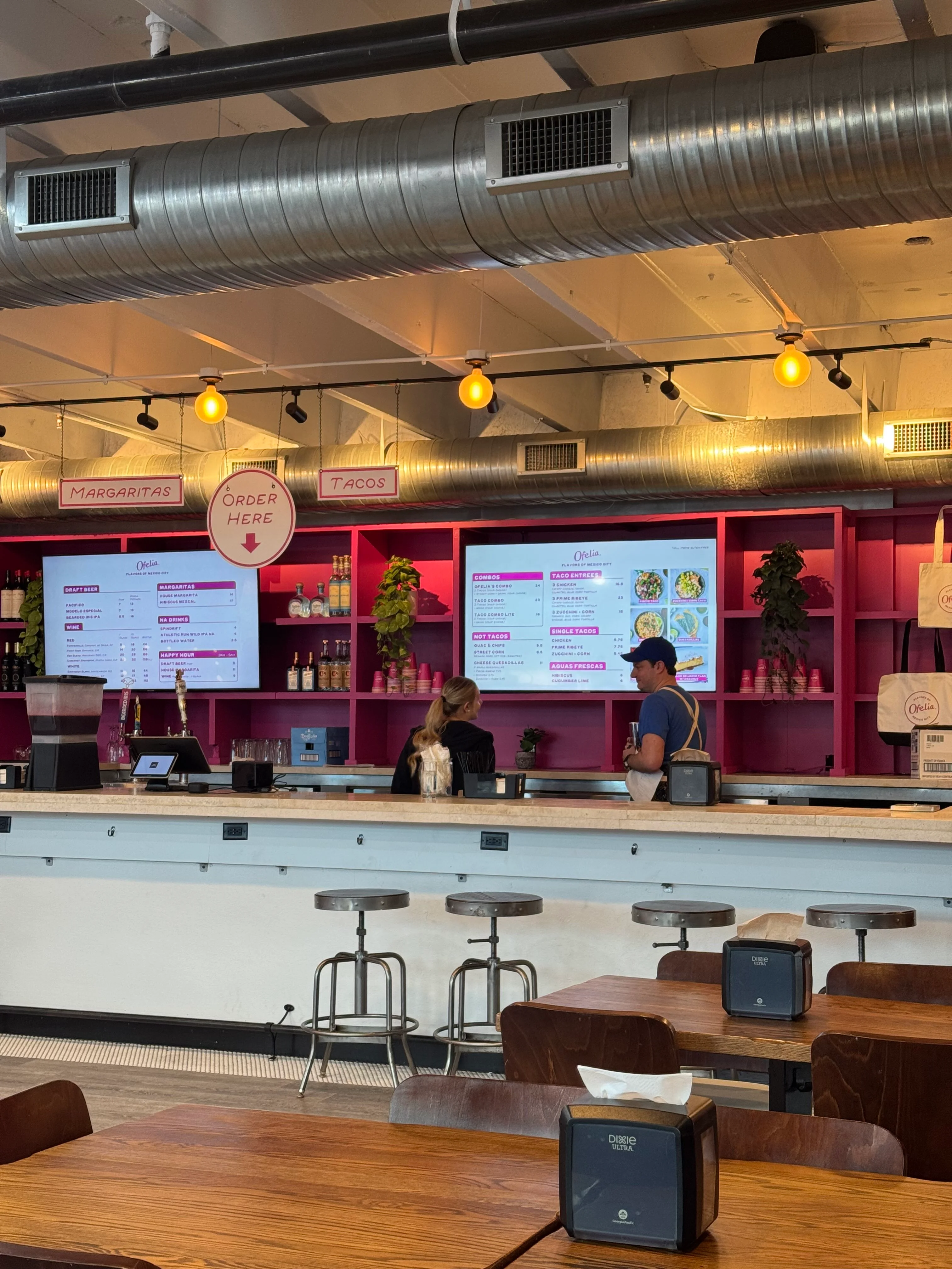 Modern restaurant interior with vibrant decor and menu displays
