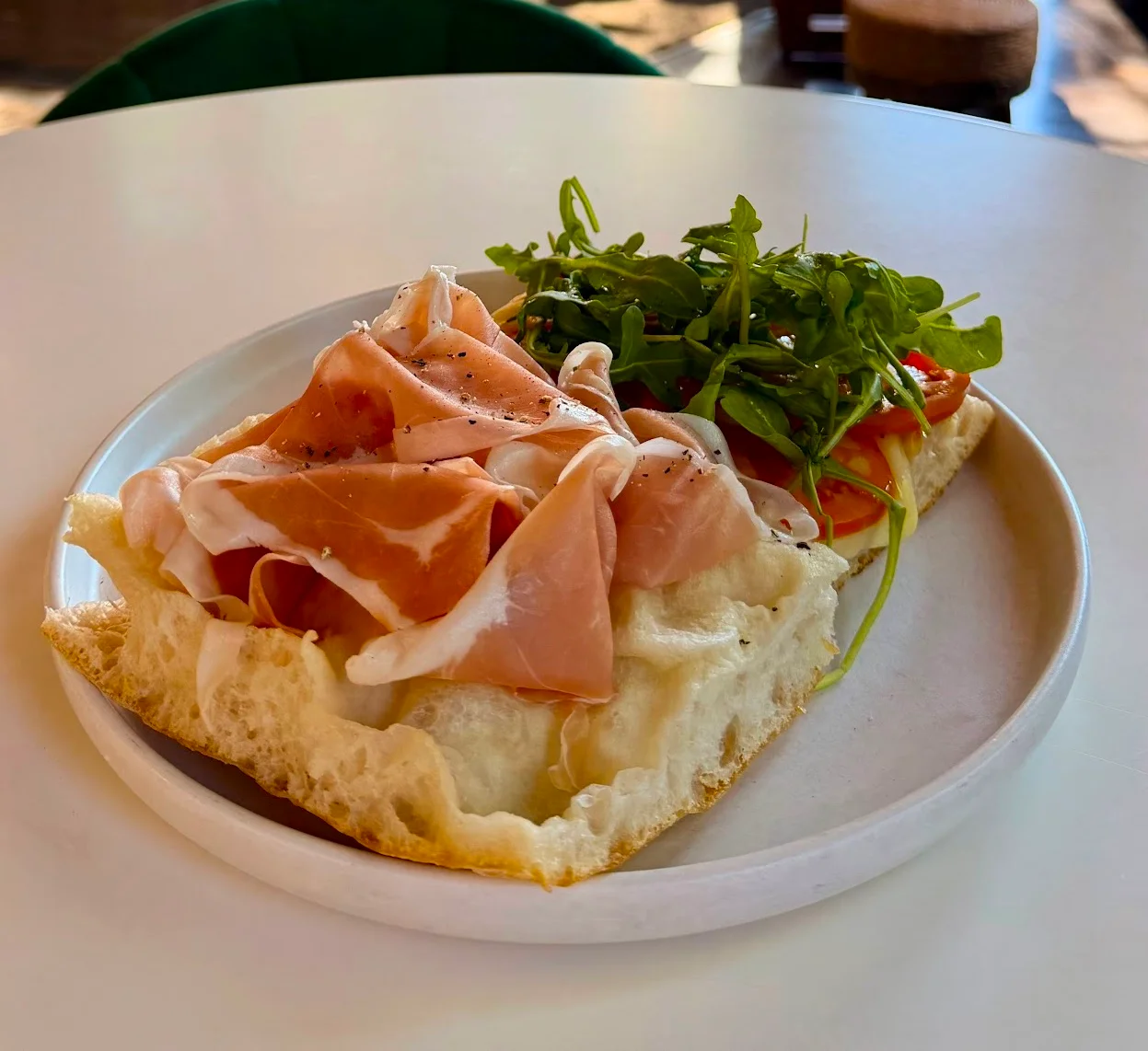 Italian panini sandwich with cured meats and arugula