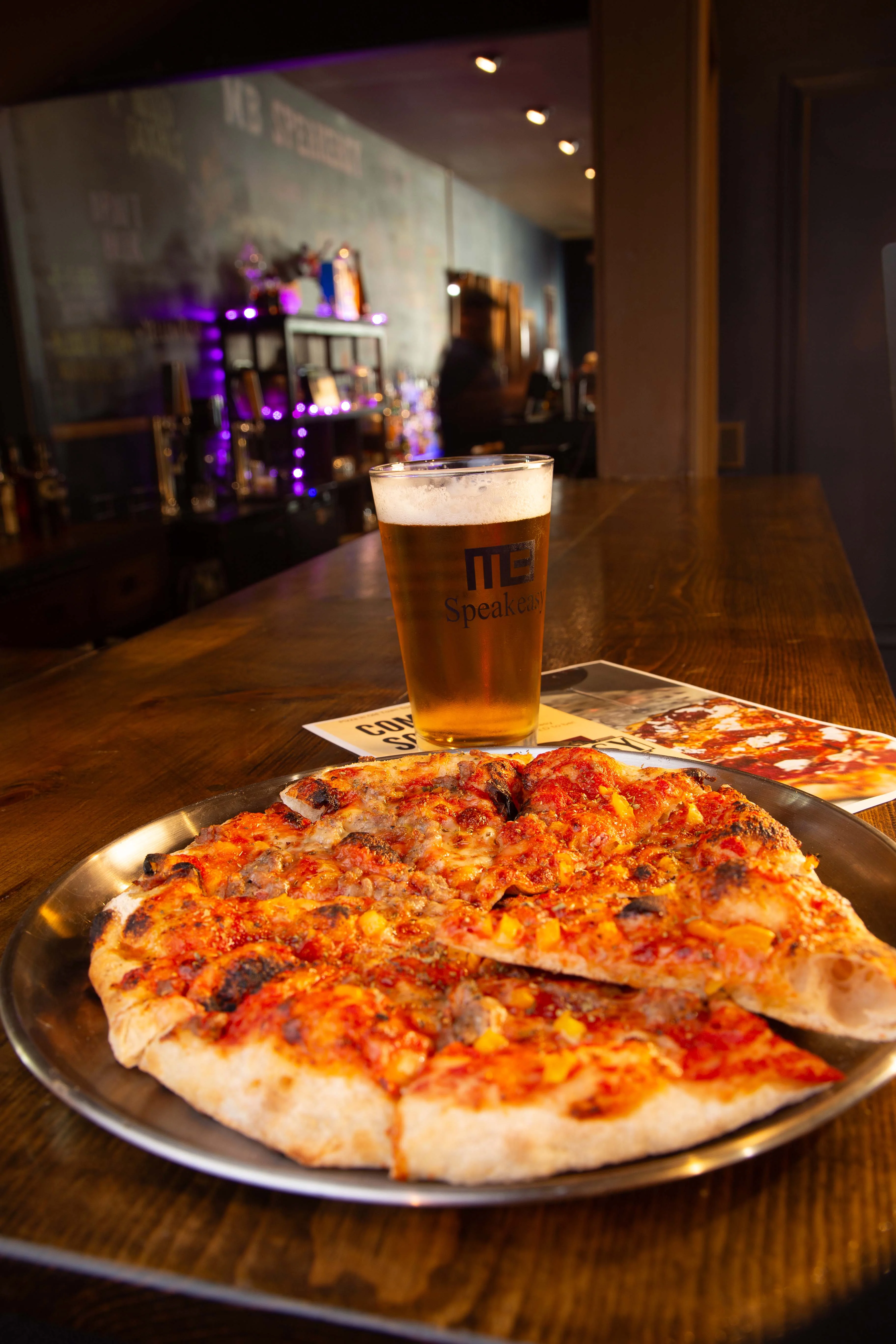 Delicious pepperoni pizza served with a cold beer