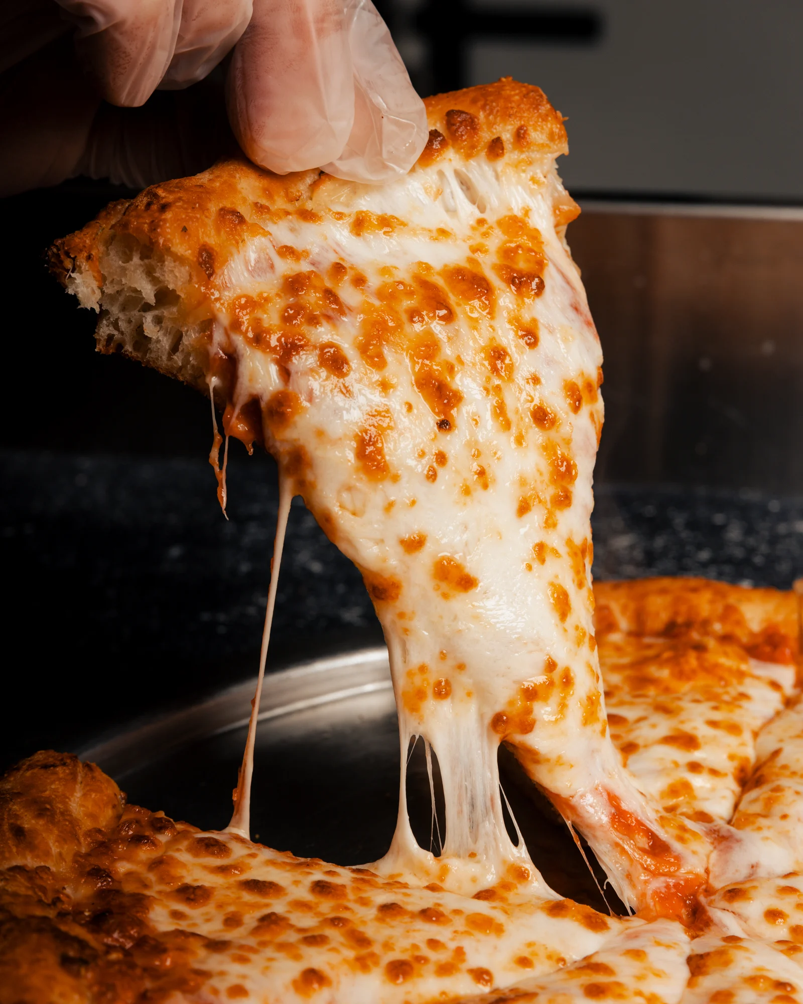Cheesy Margherita pizza slice with gooey mozzarella