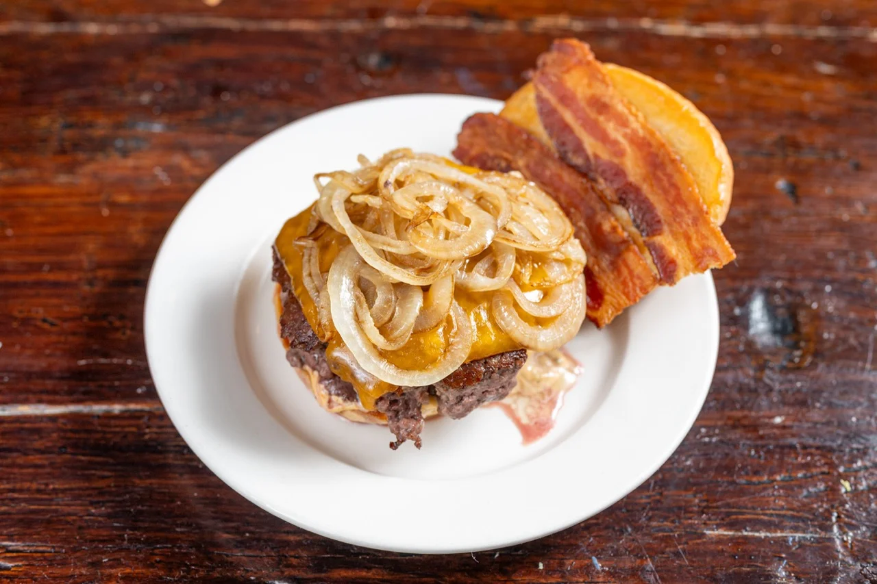 Classic American cheeseburger with bacon and grilled onions