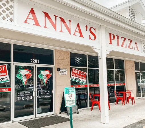 Exterior view of Anna's Pizza restaurant with take-out signage