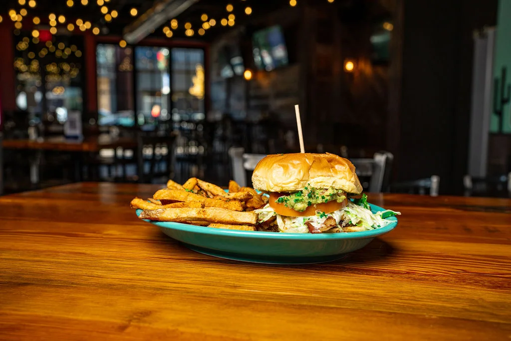 Juicy burger with fries in a vibrant restaurant setting