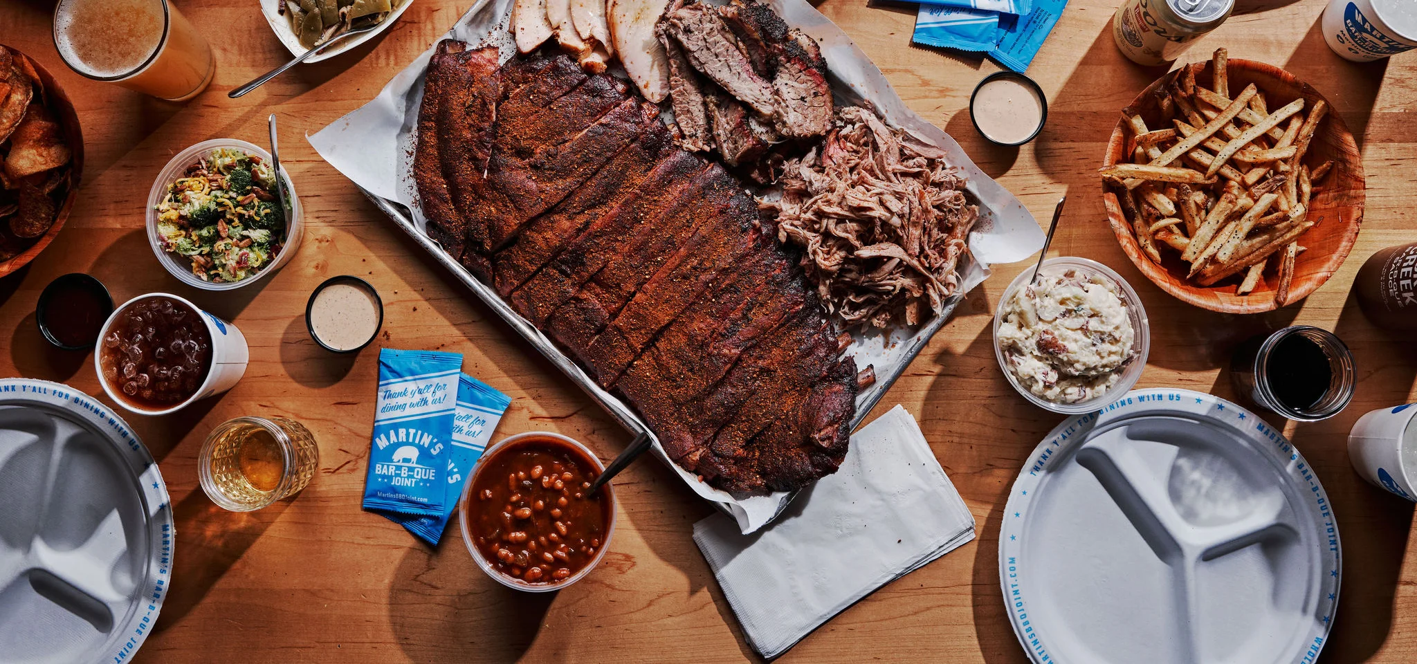 A spread of BBQ with a graphic titled "Red, White & 'Que" with a rocket and pig. A side banner states to "Place Your Order Today!".