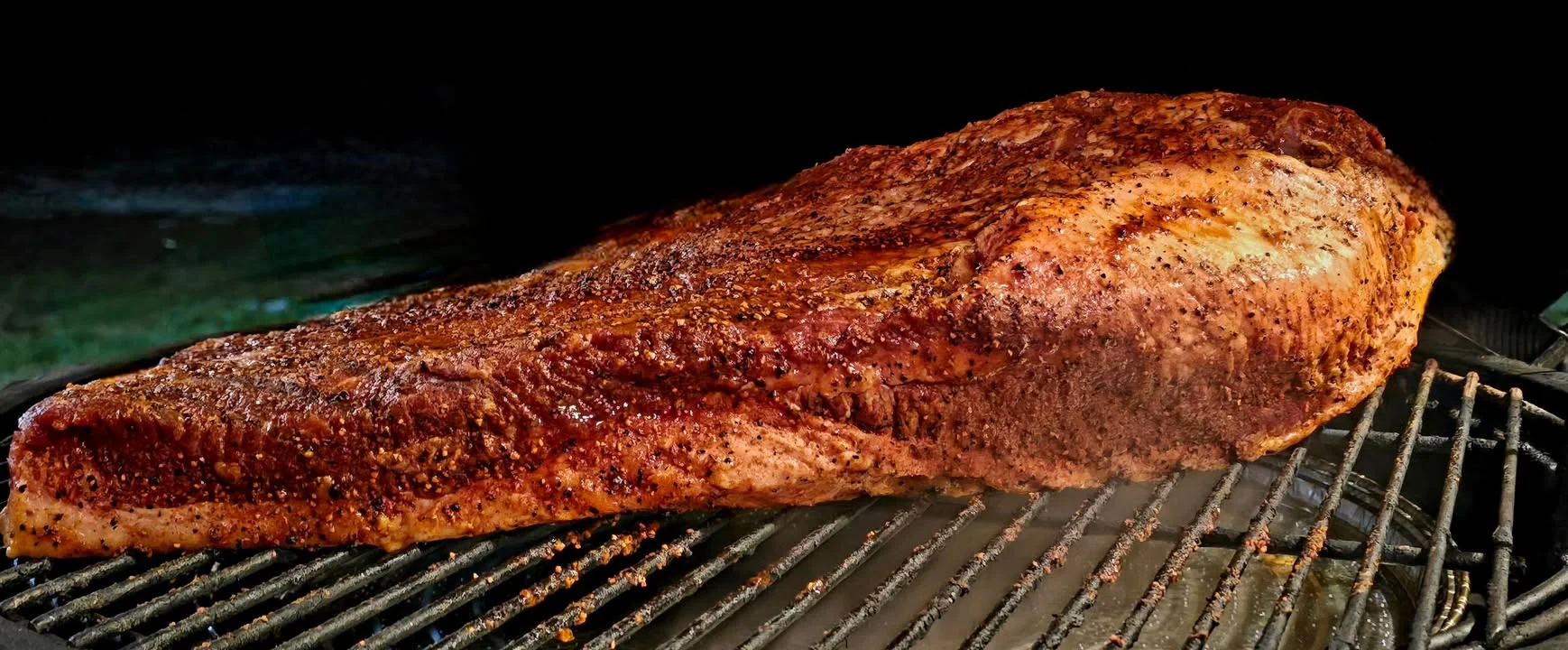 Smoked brisket on a grill, showcasing barbecue culture