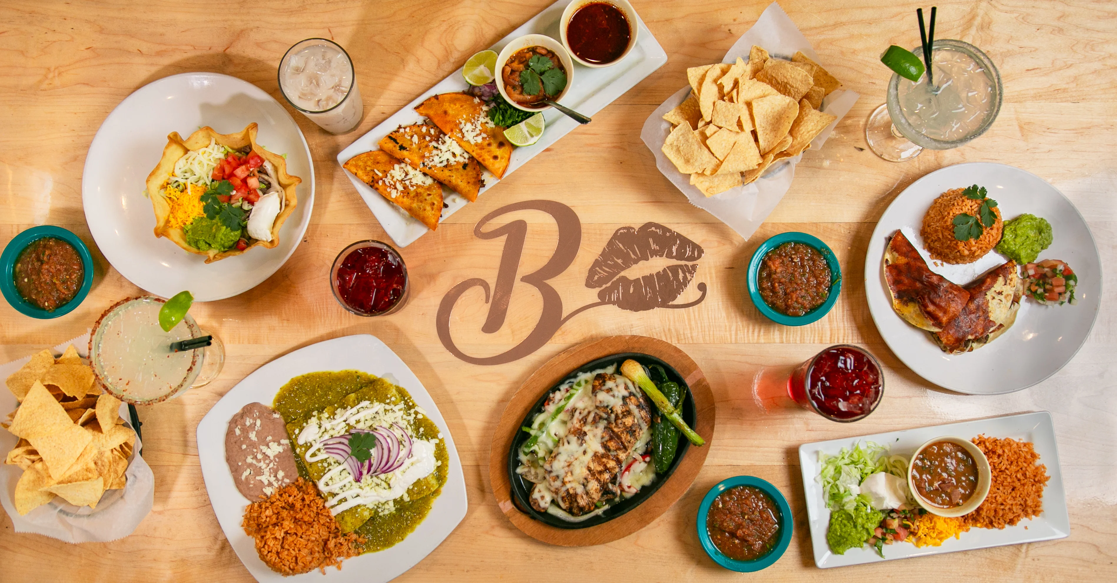 Colorful Mexican feast with tacos, enchiladas, and guacamole
