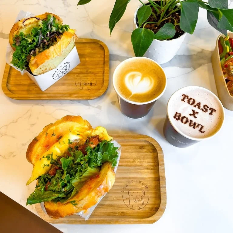 Gourmet sandwich and latte art at a cozy café