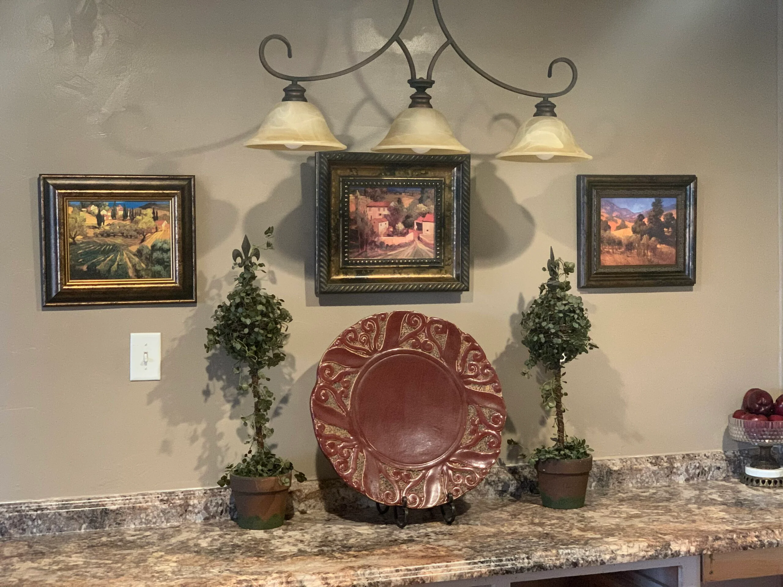 Decorative kitchen display with art and pottery