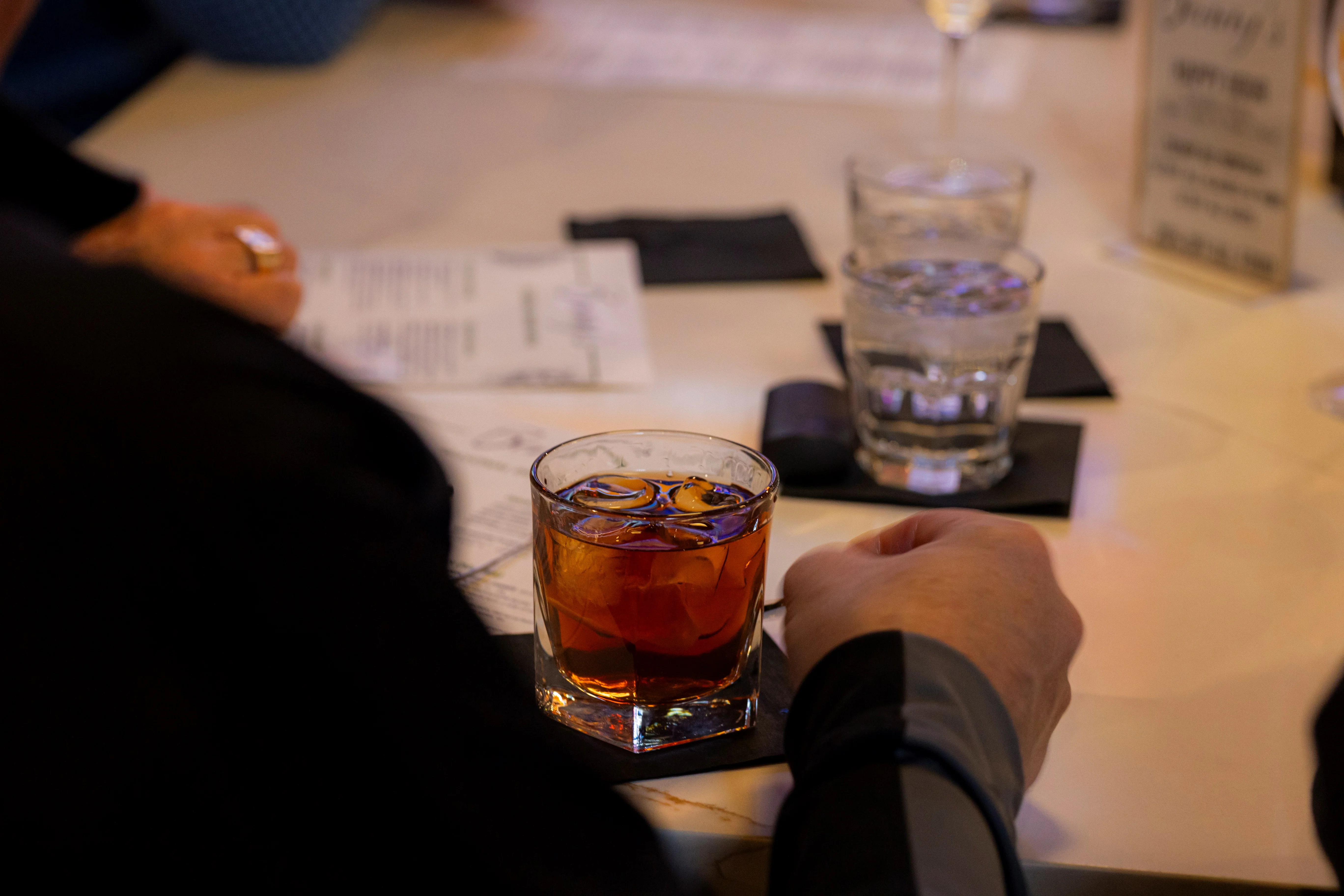 Classic Old Fashioned cocktail served on a bar table