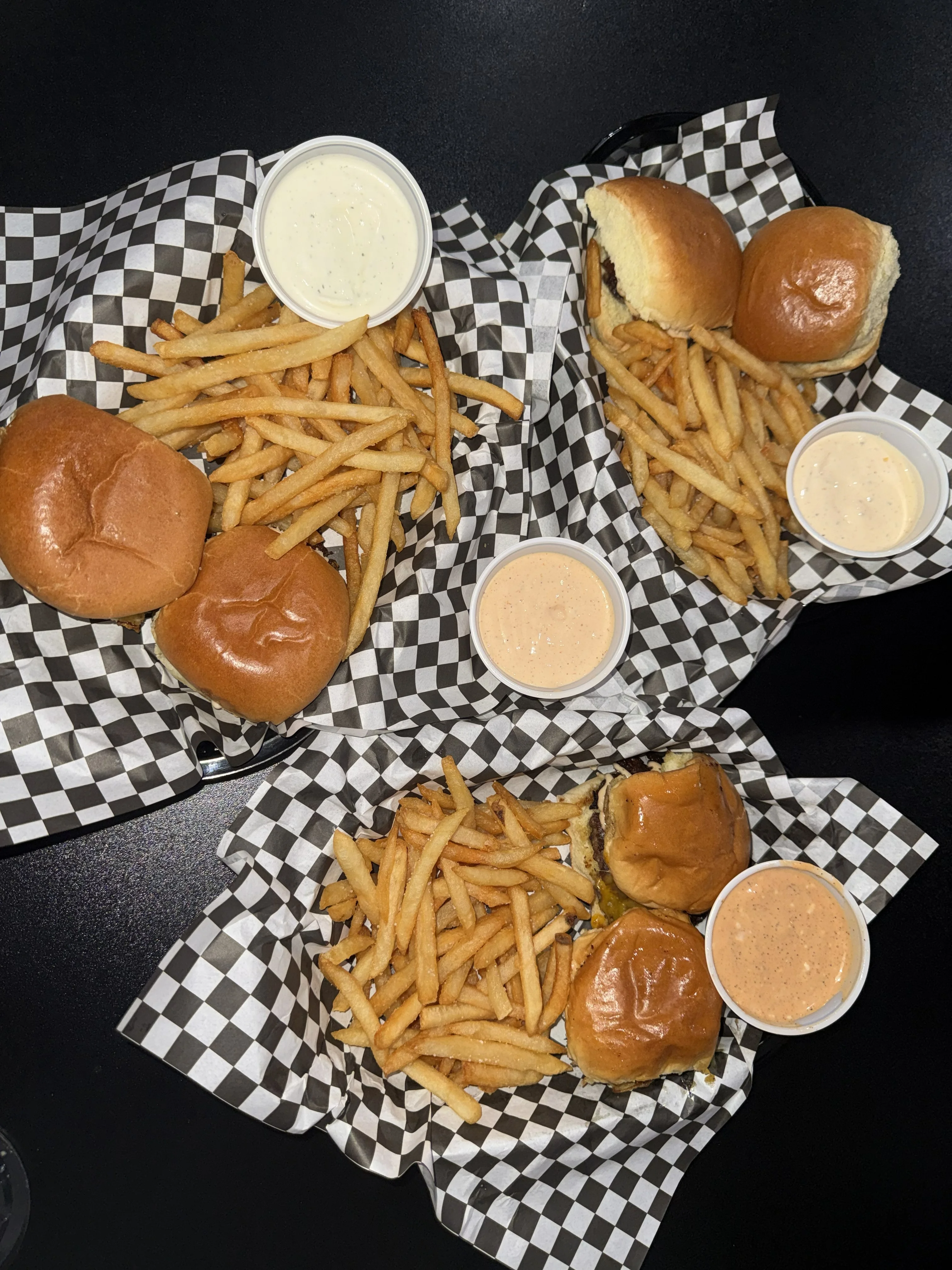 American-style burgers with French fries and dipping sauces