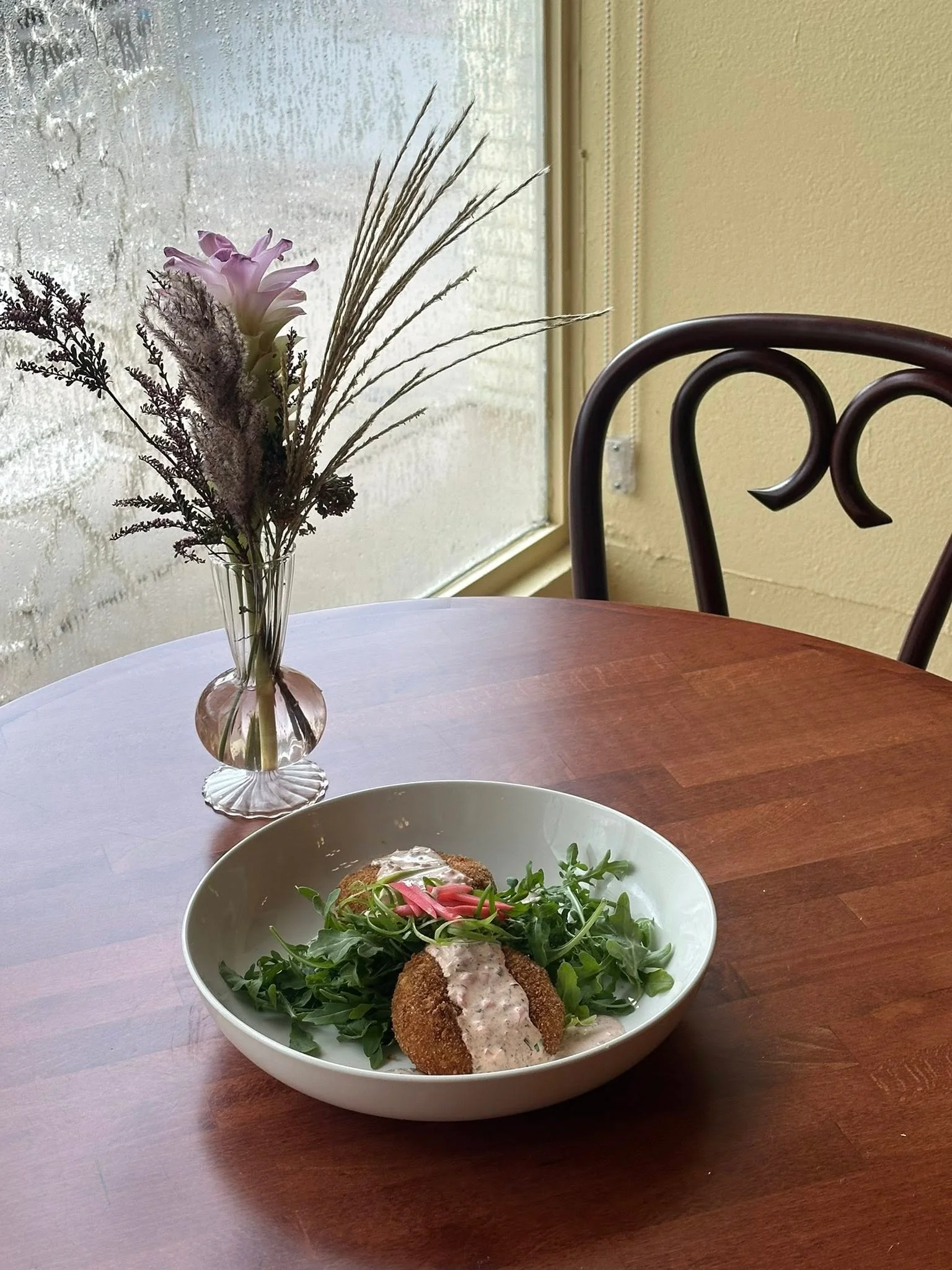Crispy falafel served on a bed of arugula with sauce