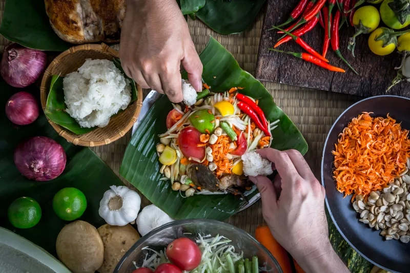 Thai som tam salad with sticky rice and fresh vegetables