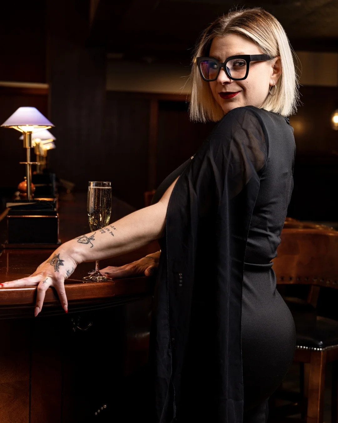 Bass Street staff member at the bar with champagne in downtown Moline, IL