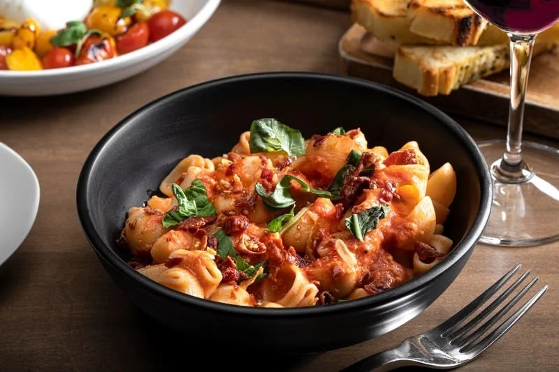 Italian pasta dish with tomato sauce and fresh basil
