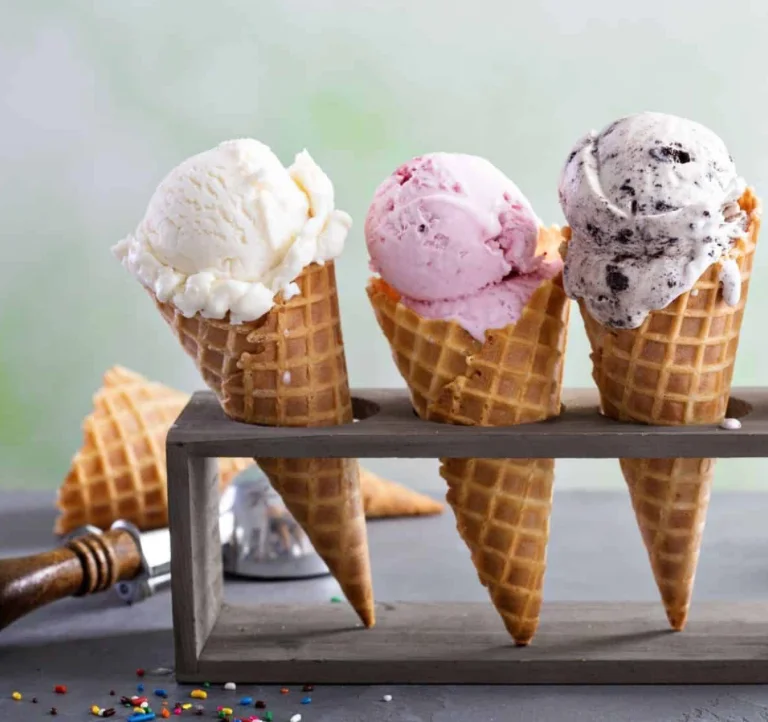 Three colorful ice cream cones in a wooden holder