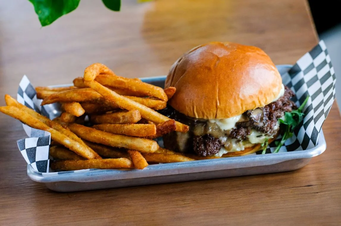 Juicy cheeseburger with crispy fries served in a diner-style tray