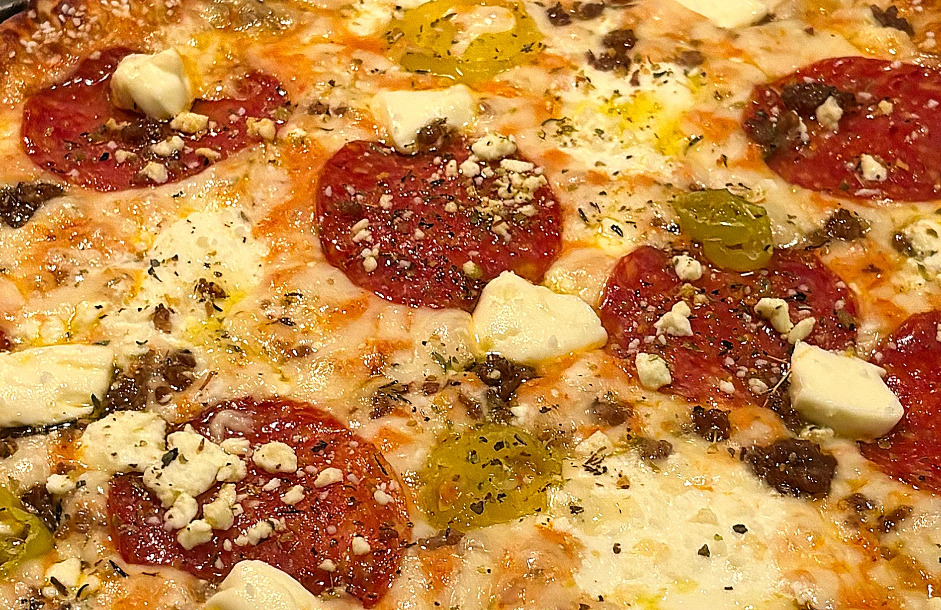 Pepperoni pizza with cheese and herbs
