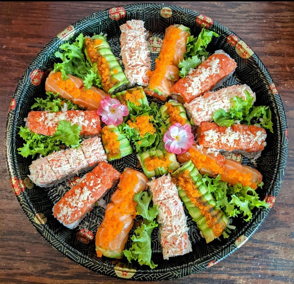 Assorted sushi platter with vibrant rolls and fresh greens