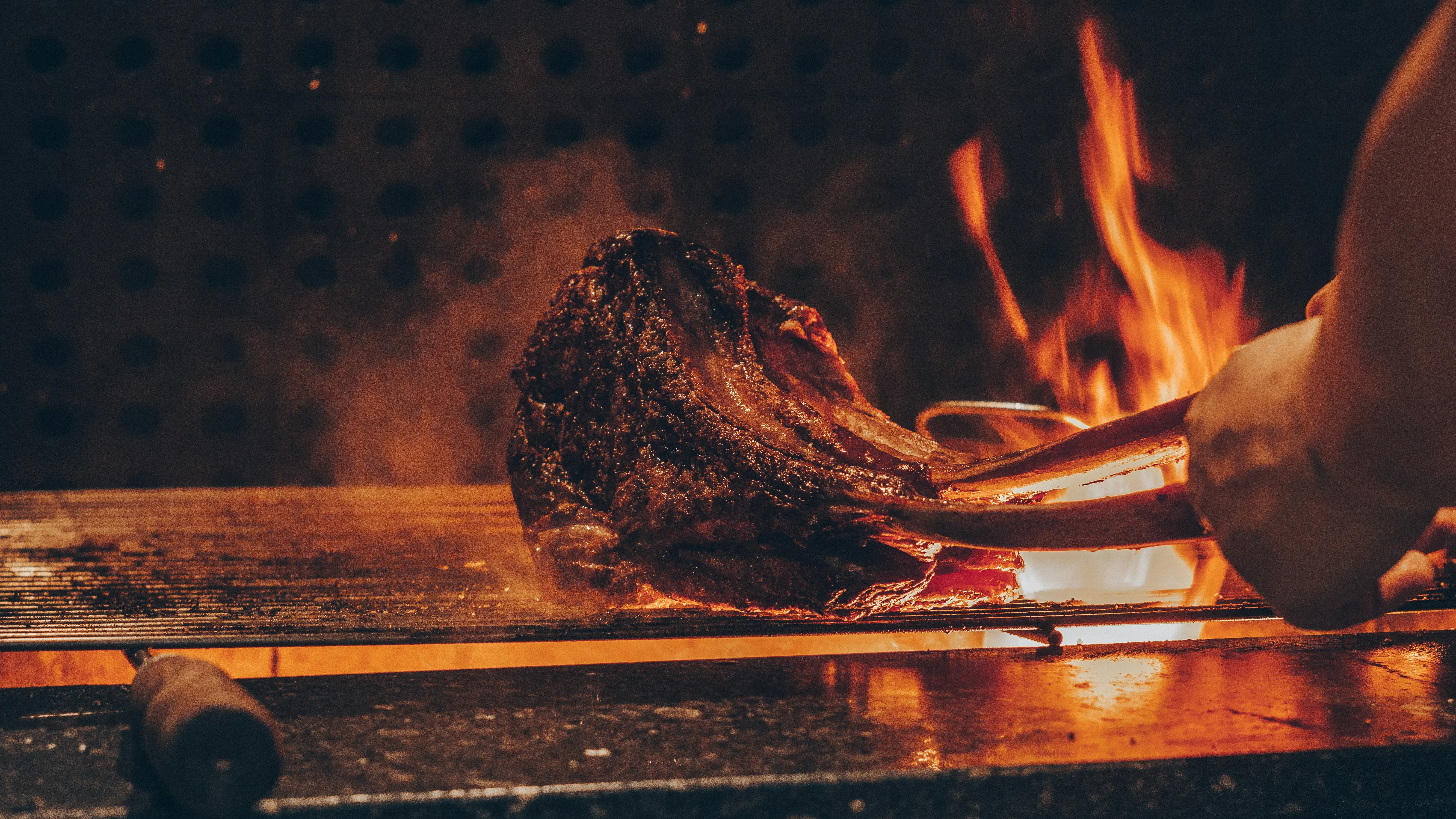Grilled tomahawk steak over open flames